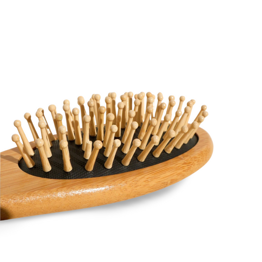 Wooden hairbrush with bristles on a white background
