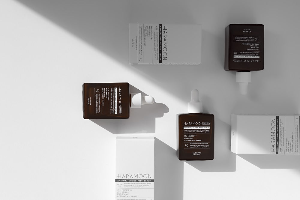 Dropper bottle of HARAMOON Immortal Peptide Serum on sunlit matte surface