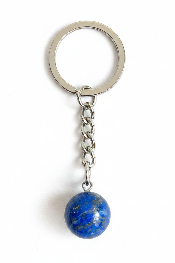 A silver metal keychain with a round key ring, short chain, and a dangling blue stone bead charm on a white background.