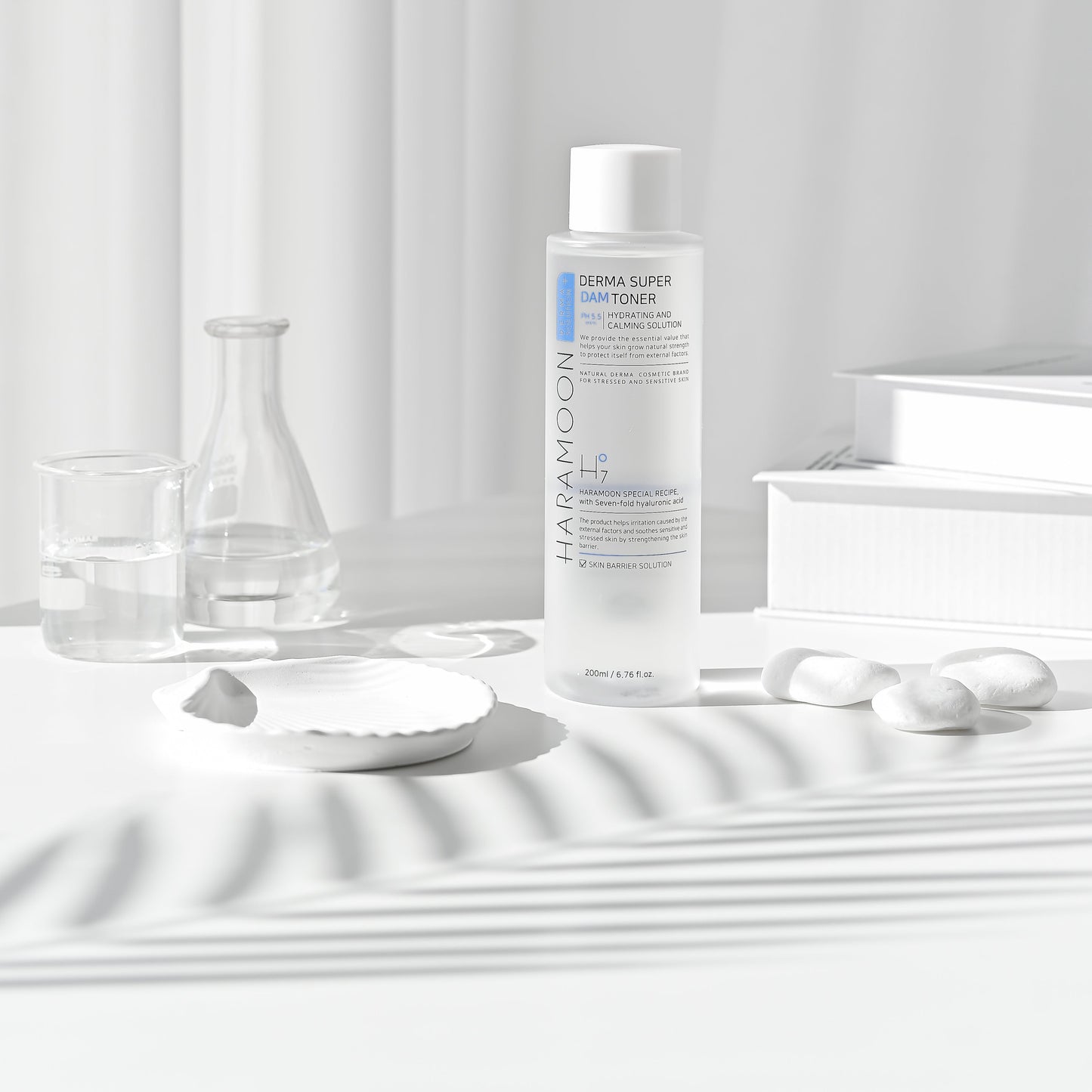 Bottle of HARAMOON Clear and Clean Toner next to cotton pads