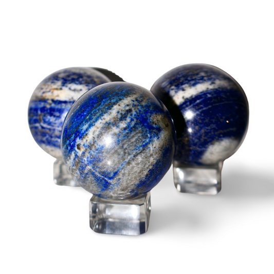 1.5-inch lapis lazuli crystal sphere with pyrite inclusions, showing deep indigo color and golden flecks on a white background.