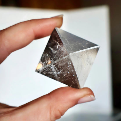 crystal pyramid close-up with light reflections on polished surfaces
