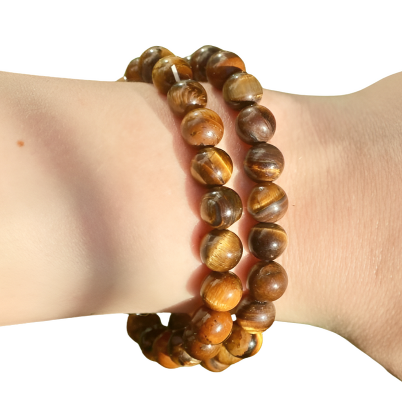 tigers eye beaded bracelet on a wrist against a white background