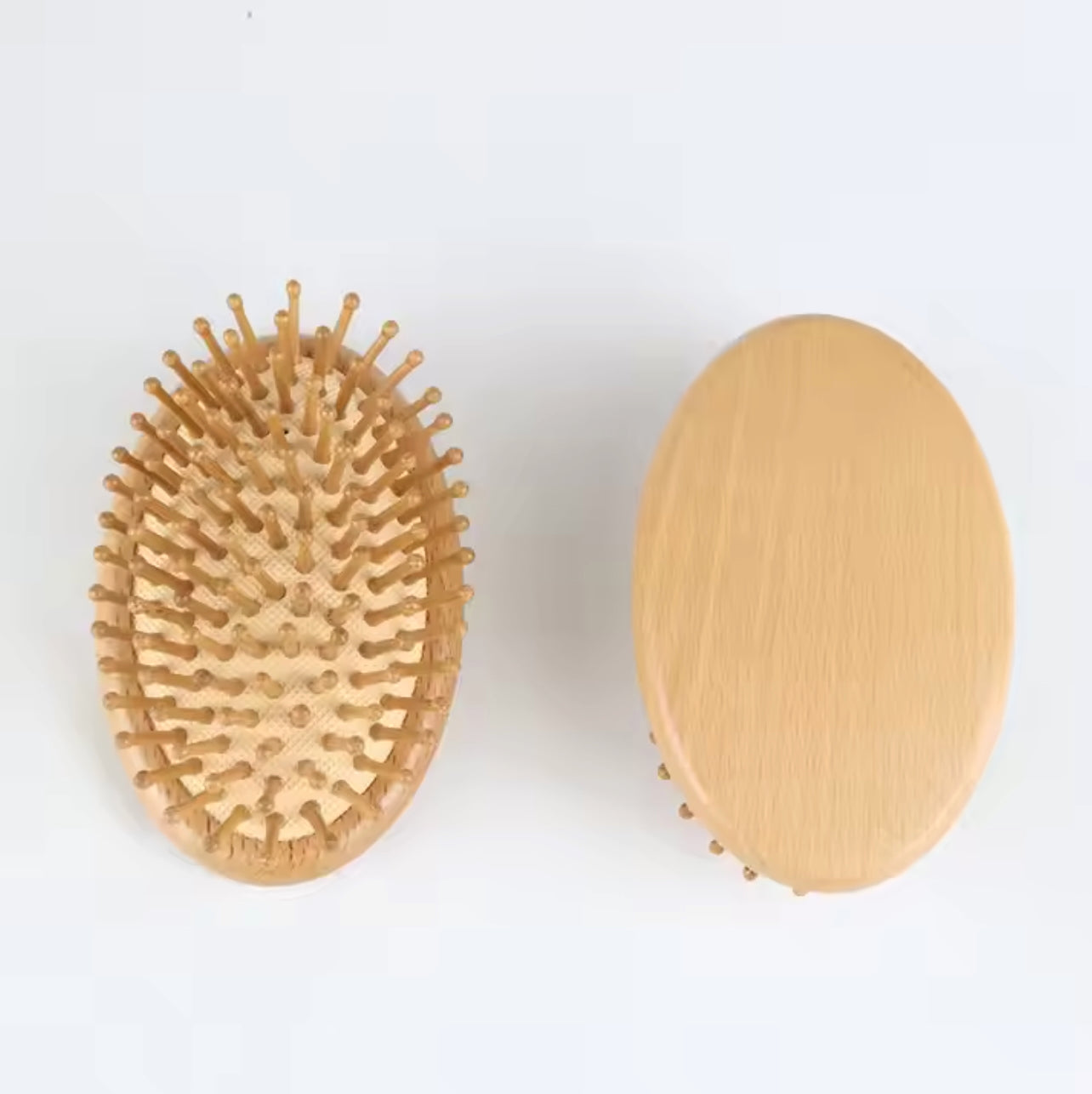 Eco-friendly handheld brush featuring a smooth bamboo base and rounded wooden bristles for comfortable hair brushing.