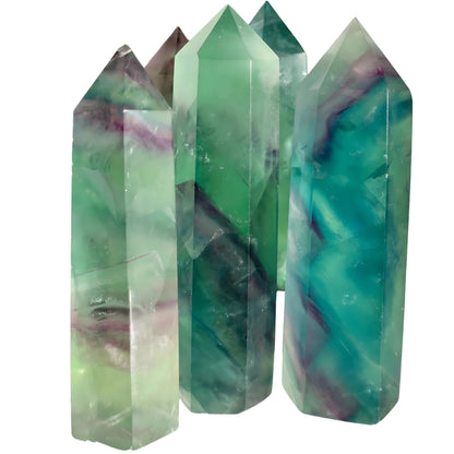 textured Fluorite Obelisk in Green and Purple in studio background