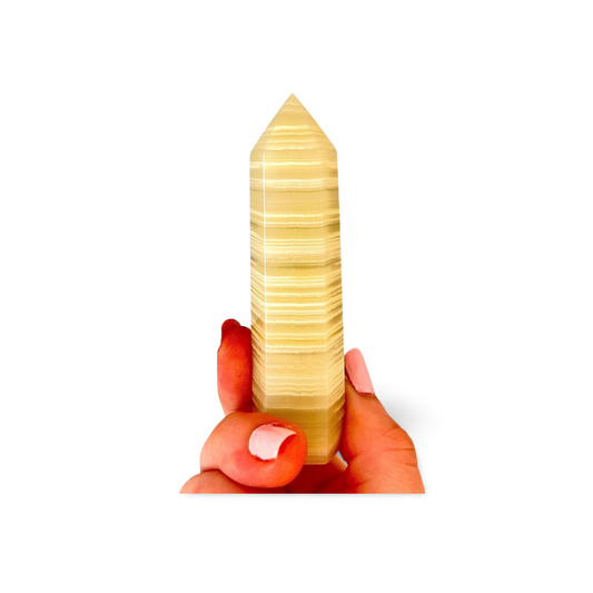 Hand holding a jade crystal on a white background