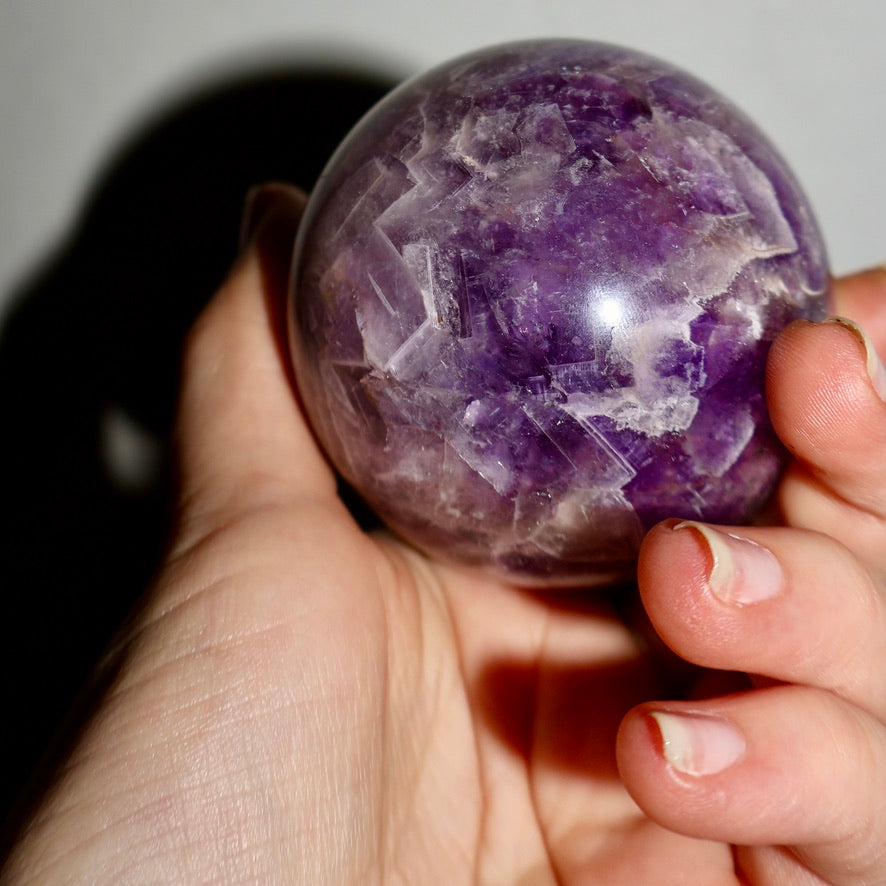 Huge 3 inch Diameter Purple_Chevron_Amethyst_Crystal_Sphere in Hand Vivid