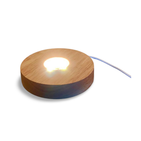Wooden LED light base with warm glow, USB cord attached, for displaying crystals and spheres.
