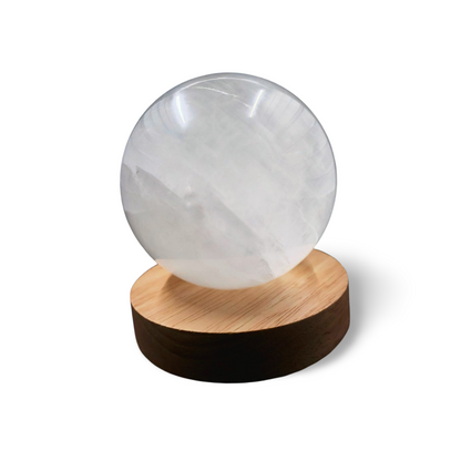 Wooden LED light base with warm glow, USB cord attached, for displaying crystals and spheres.