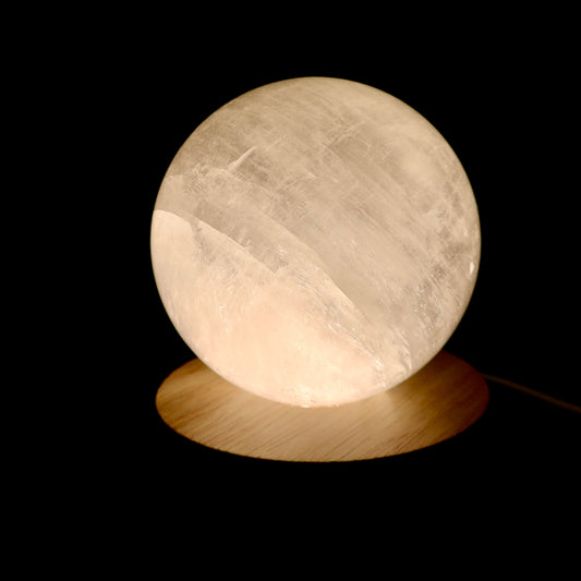 Wooden LED light base with warm glow, USB cord attached, for displaying crystals and spheres.