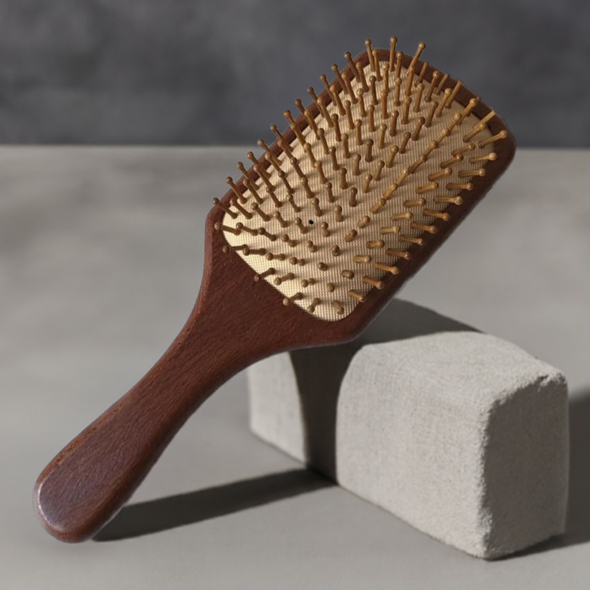 Premium sandalwood hair brush with ergonomic handle and wooden bristles for scalp stimulation.