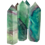 textured Fluorite Obelisk in Green and Purple in studio background