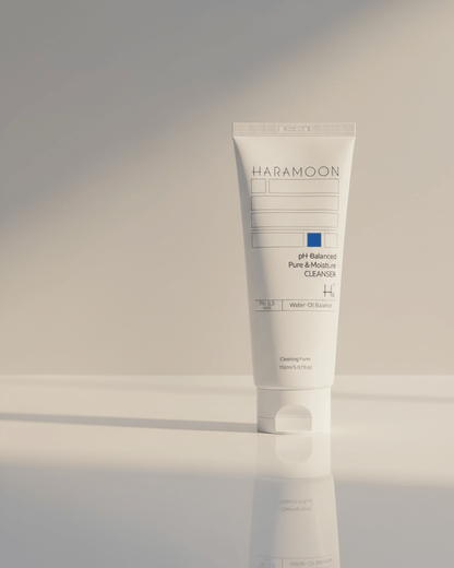 Tube of HaraMoon skincare product on a reflective surface with a neutral background