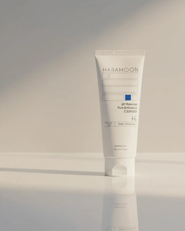 Tube of HaraMoon skincare product on a reflective surface with a neutral background