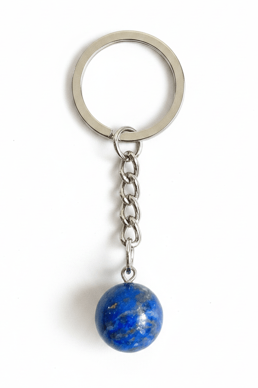 A silver metal keychain with a round key ring, short chain, and a dangling blue stone bead charm on a white background.