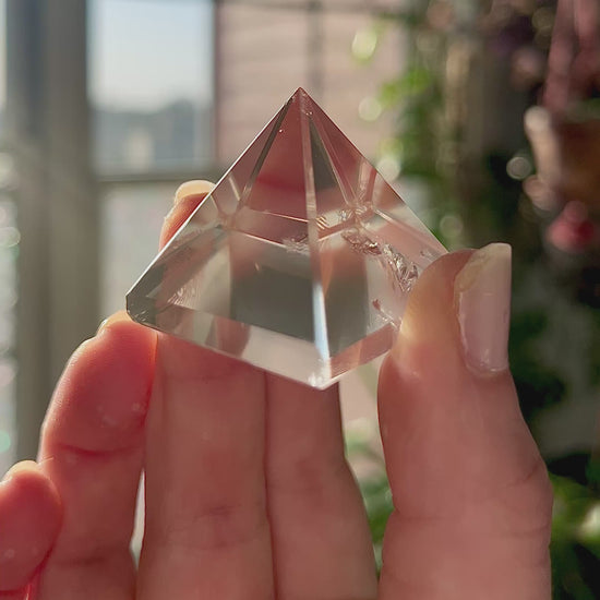 crystal pyramid close-up with light reflections on polished surfaces