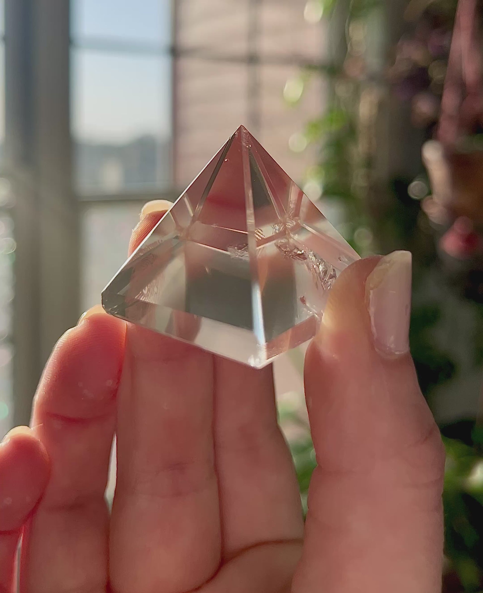 crystal pyramid close-up with light reflections on polished surfaces