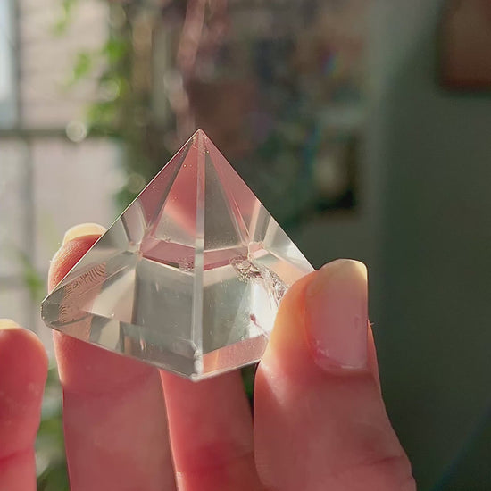 crystal pyramid close-up with light reflections on polished surfaces