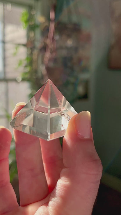 crystal pyramid close-up with light reflections on polished surfaces