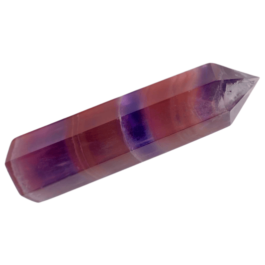 Crystal prism with purple and red bands on a white background